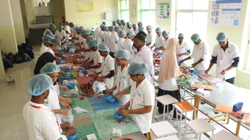 JKKN Dental College preclinical lab with students practicing dental procedures at workbenches